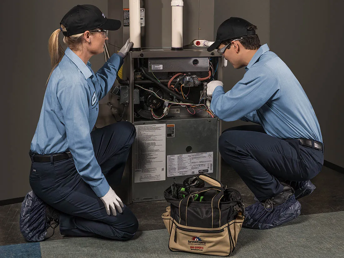 Service Experts technicians repairing a furnace
