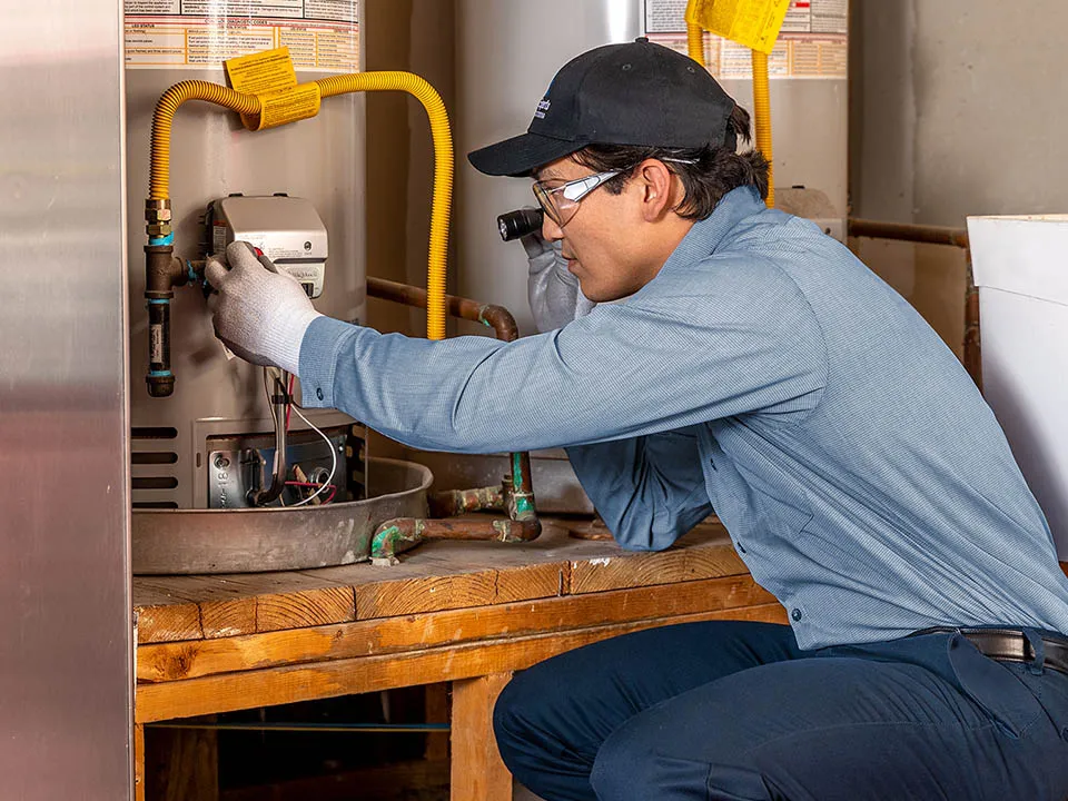 Service Experts technician servicing a water heater